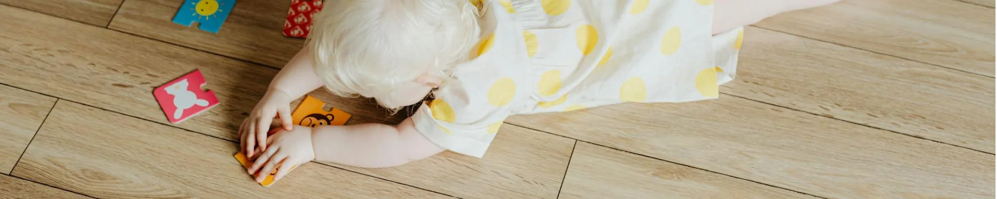 Child laying comfortably and playing on luxury vinyl flooring