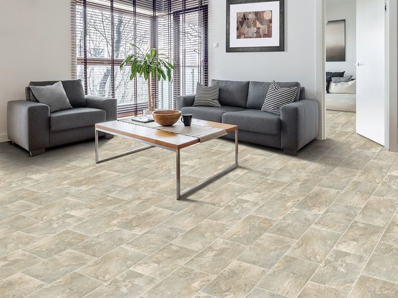 Light brown wood-look flooring in a family room with fireplace.